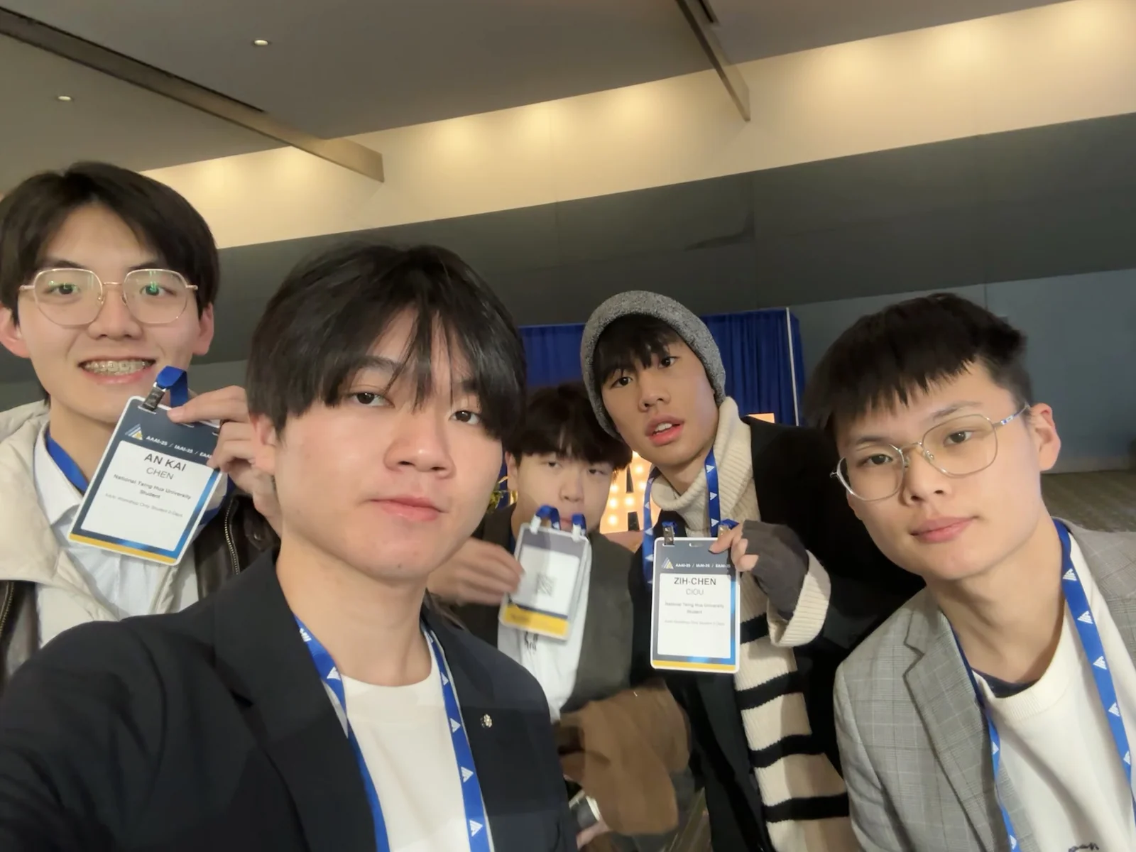 Five teammates arriving with AAAI workshop badges, 3 March 2025
