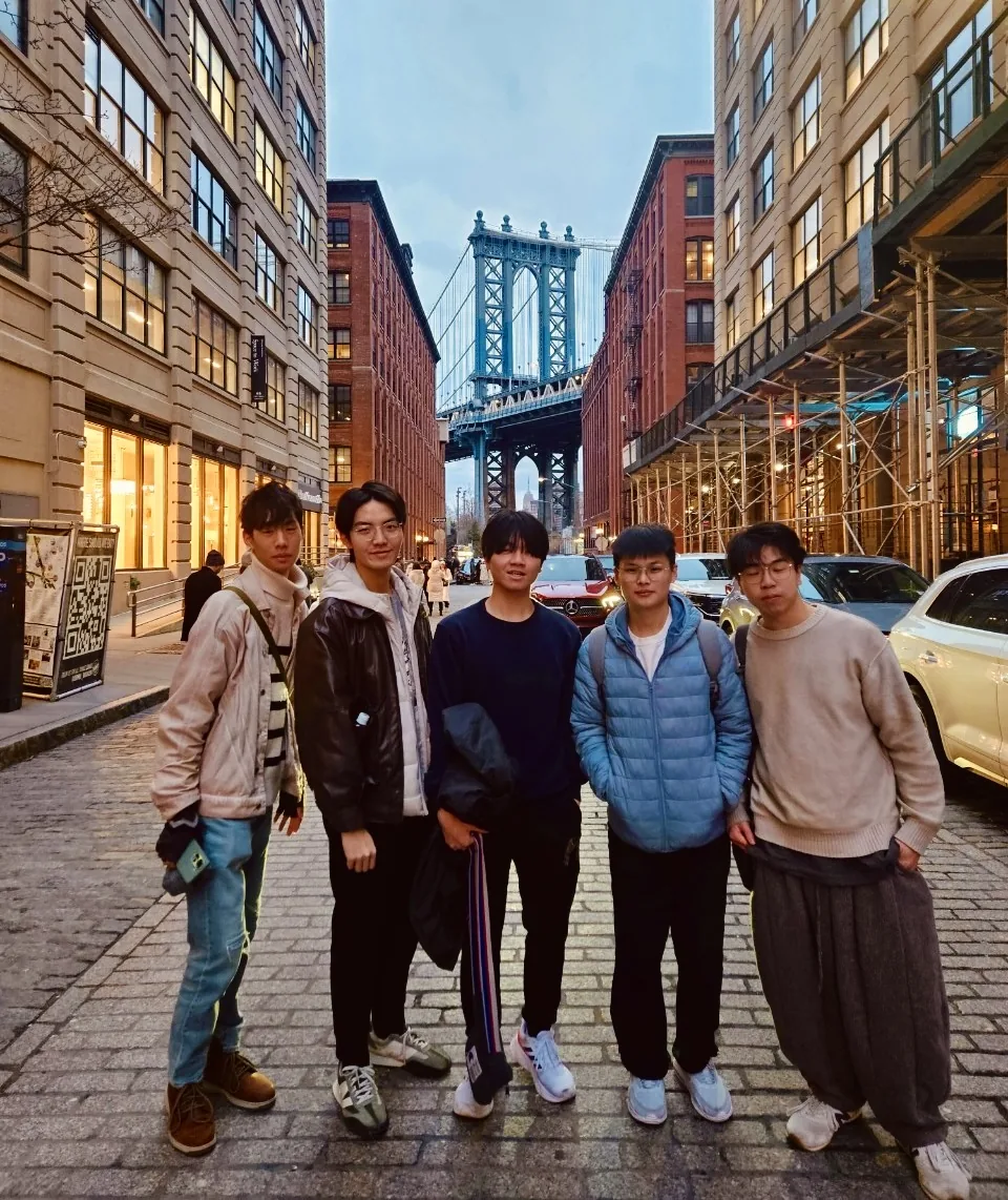 Five teammates beneath Manhattan Bridge during the New York leg